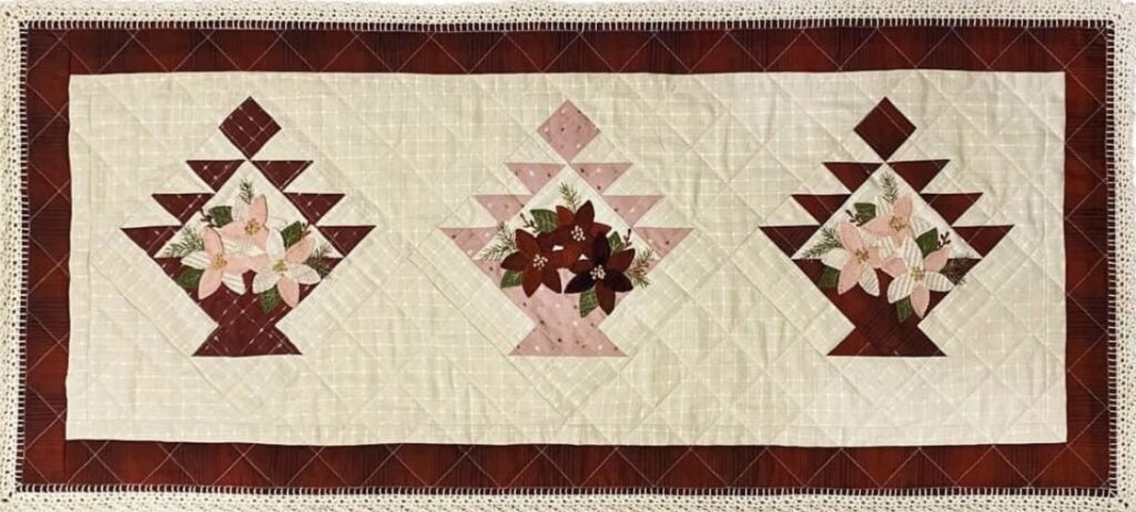 “Christmas in Bloom” designed by Kellie Beckwith, owner of Tulip Cottage Quilts, and KL Designs. A fusion of quilting, wool appliqué and crochet. Finished size is 19” x 42.5” | KLDesignsOnline.com | Wool Applique Patterns by Karen Yaffe